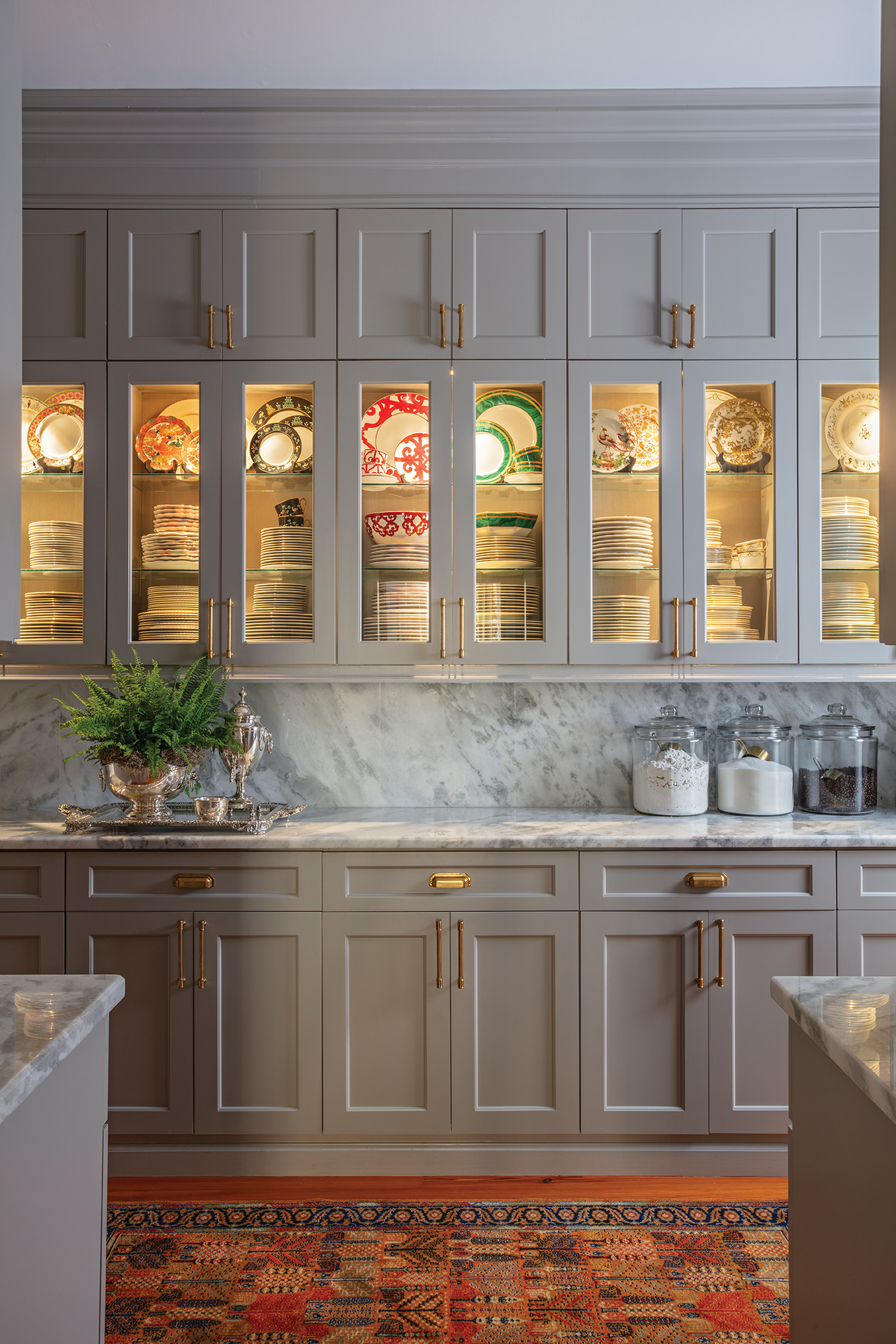 Cabinets galore and a butler’s pantry allow for uncluttered counter space. “No matter how big your house is, there’s never enough storage,” John says.
