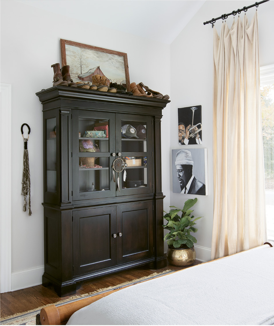 PERSONAL TOUCHES: Portraits of jazz greats Thelonious Monk and Dizzy Gillespie, painted by Jacques himself; above the cabinet is a portrait of a farm once owned by Jacques’s family, framed in wood from the very barn that’s pictured.