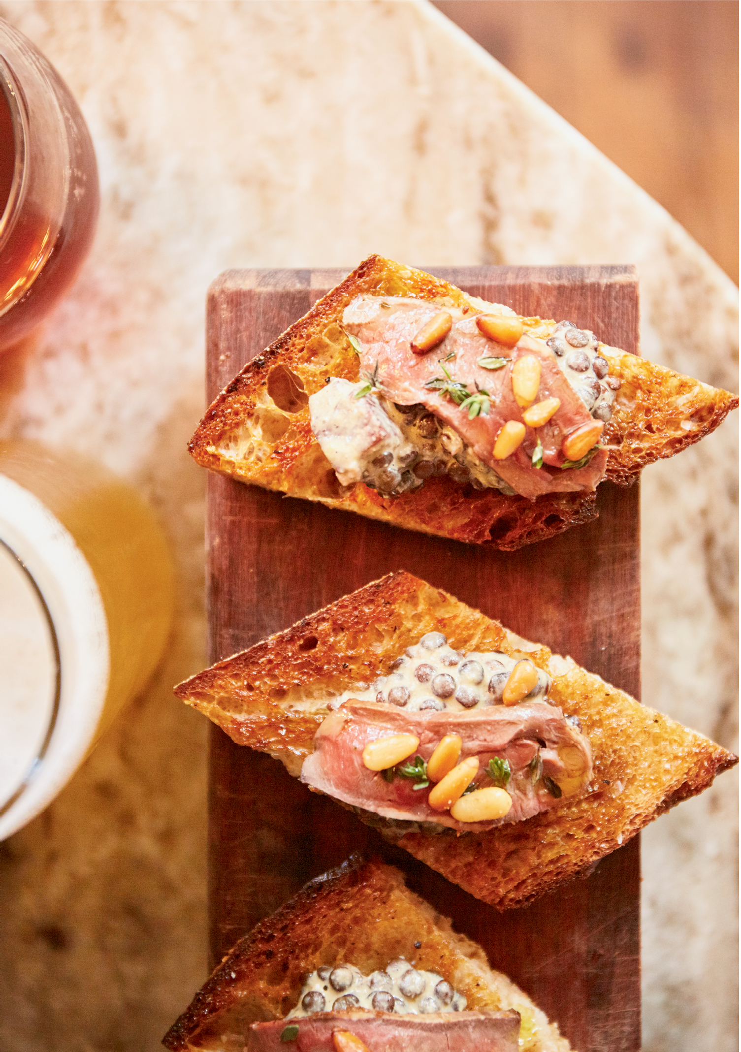 Raise A Toast: When a quirky restaurant takes up residence inside a bakery, beautiful bread is expected. Lira’s daily “toast,” a rotation of crunchy Normandy Farm baguettes rubbed with olive oil and topped with an array of ingredients, such as beluga lentils and seared pork belly, makes for a hearty starter.