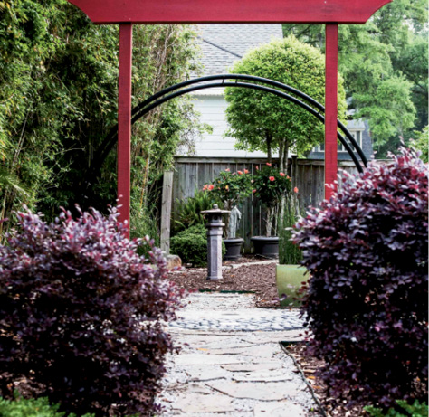 A Japanese torii gate lures visitors to the backyard.