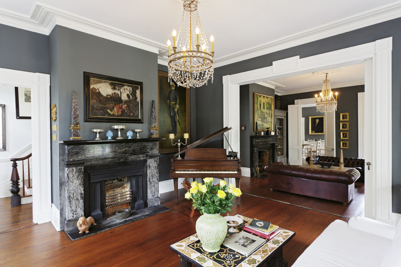 In the double parlors are paintings by John Carroll Doyle and an  anonymous Flemish piece (over the near mantel). All the downstairs living spaces are painted a hand-mixed velvet grey.