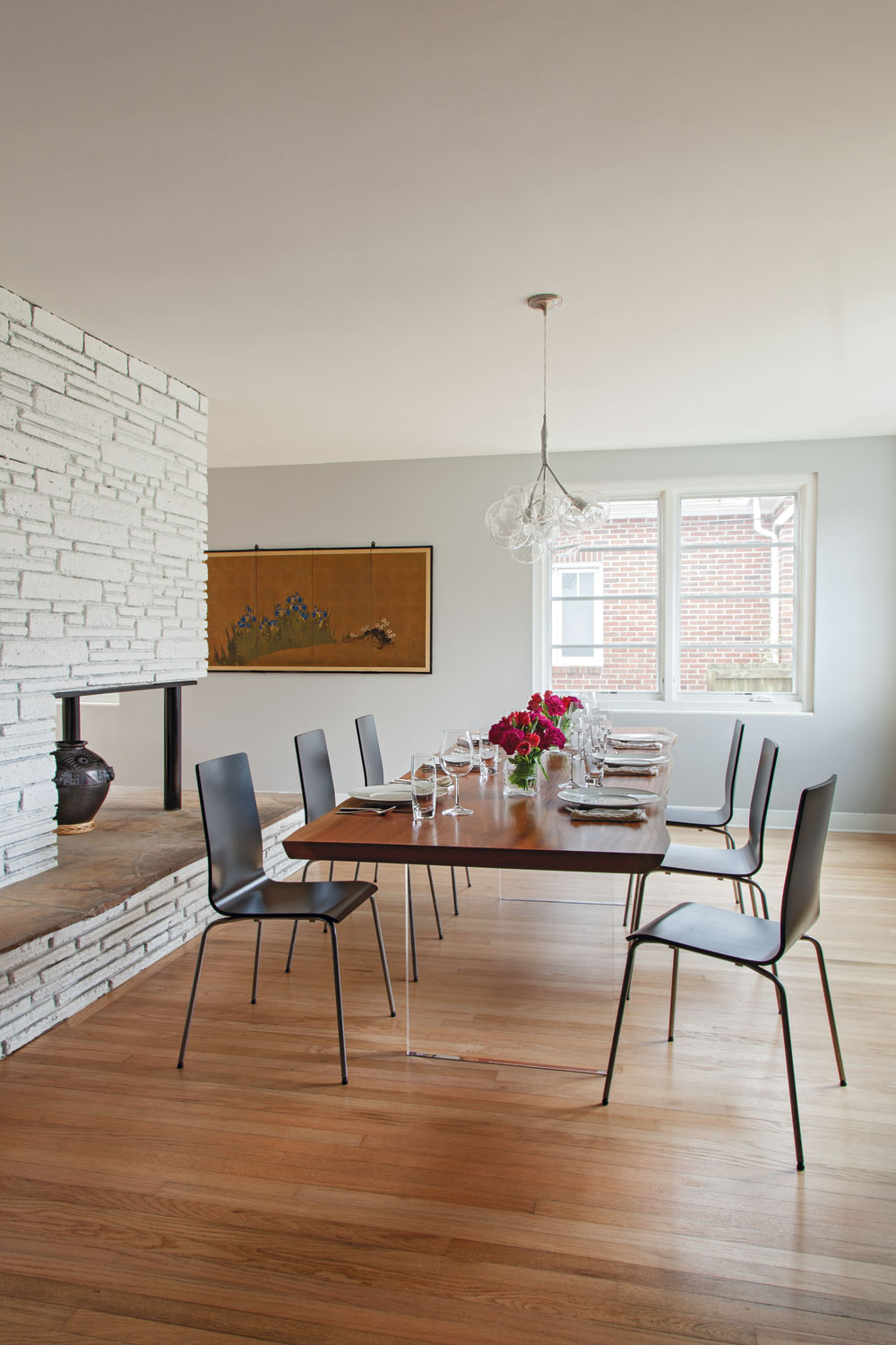 EATING LOCAL: For a sleeker take on the traditional farmhouse table, Bryan Deel of Bryan Deel Timberwerks paired a hardwood top with a pair of Lucite legs.