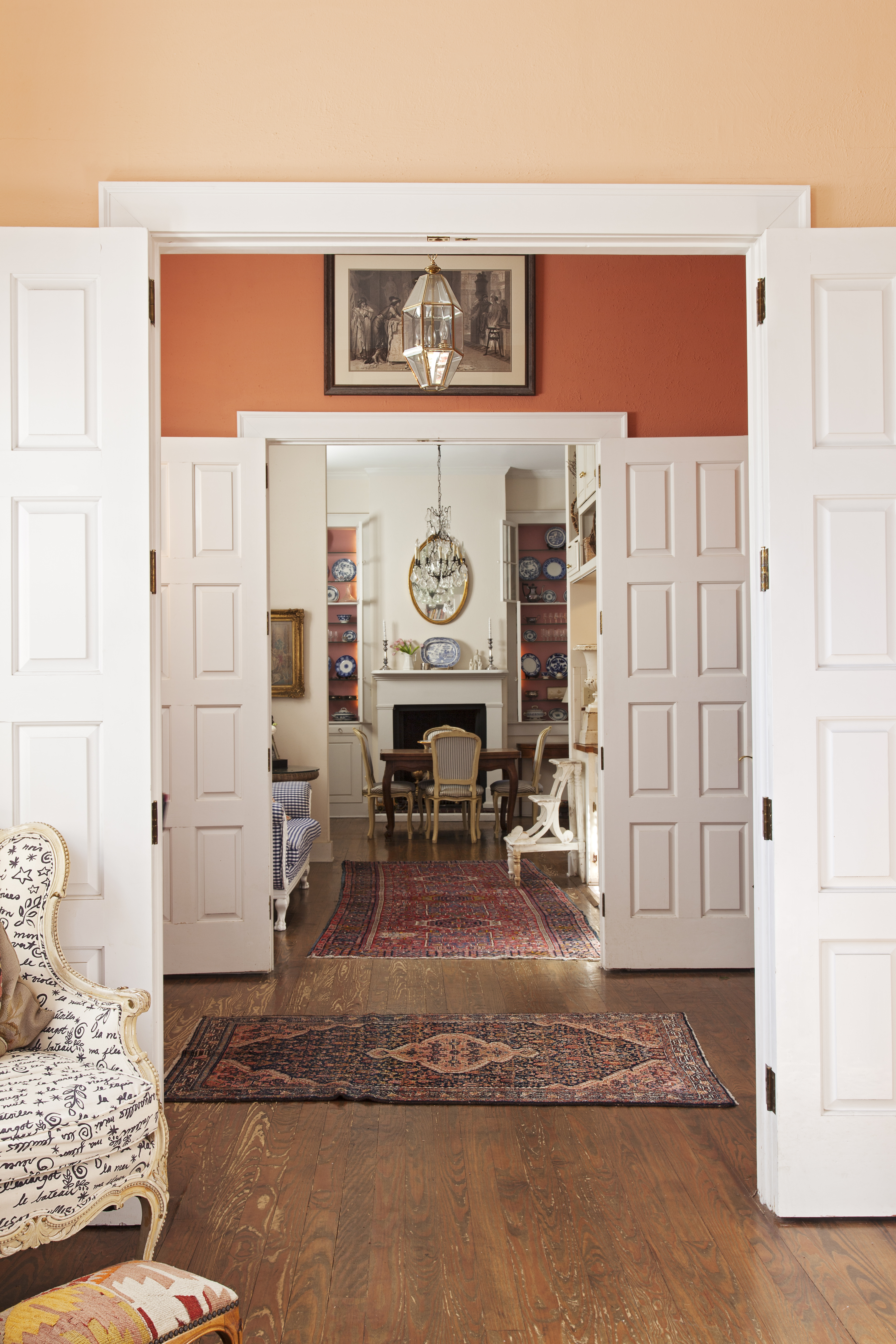 Paneled wood doors allow the space to be at turns intimate and airy.