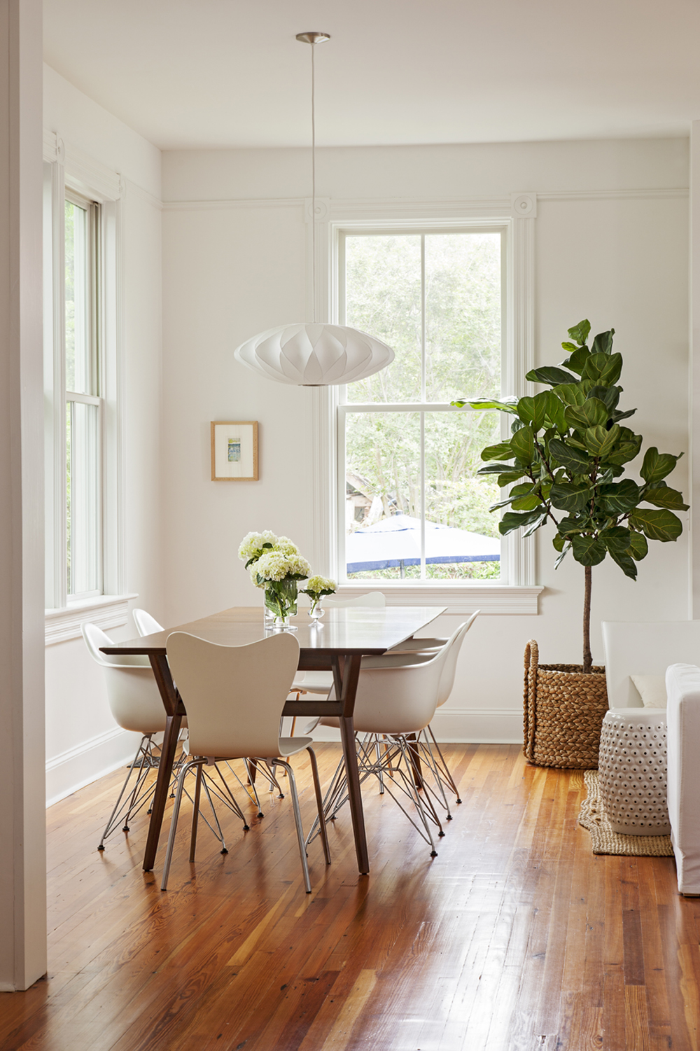 Modern History: In the addition, custom-milled trim and reclaimed floors reference the home’s original architecture, while midcentury furnishings, such as Eames dining chairs and a George Nelson light fixture, set a contemporary tone.