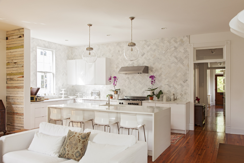 In the kitchen, marble tiles laid in a herringbone pattern are clean-lined and classic.