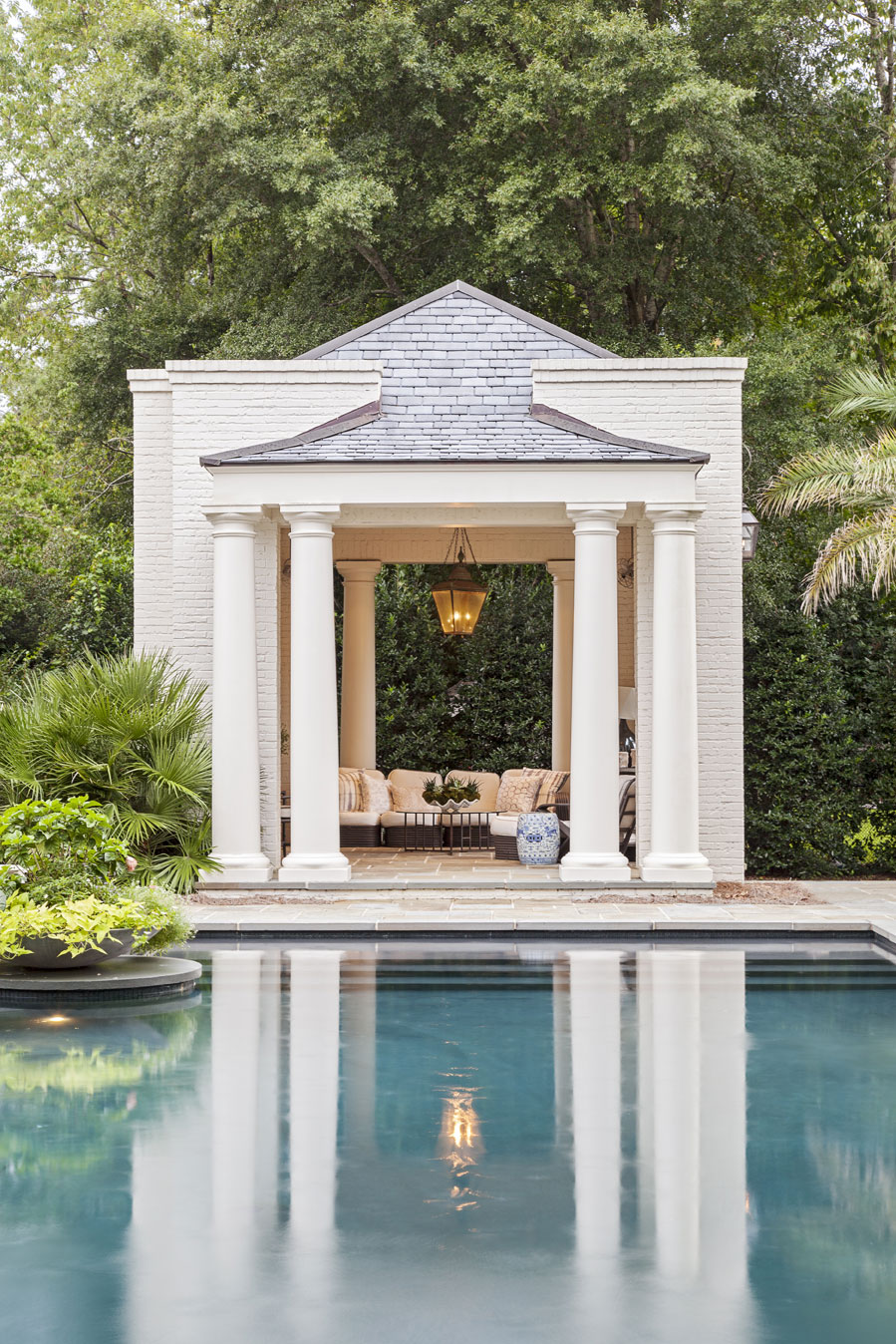 CABANA COOL: Elevated pool cabanas provide shade and a place to relax (top). A landscaped brick wall acts as a privacy screen as the Hastings boys face off in the pool for a game of chicken.