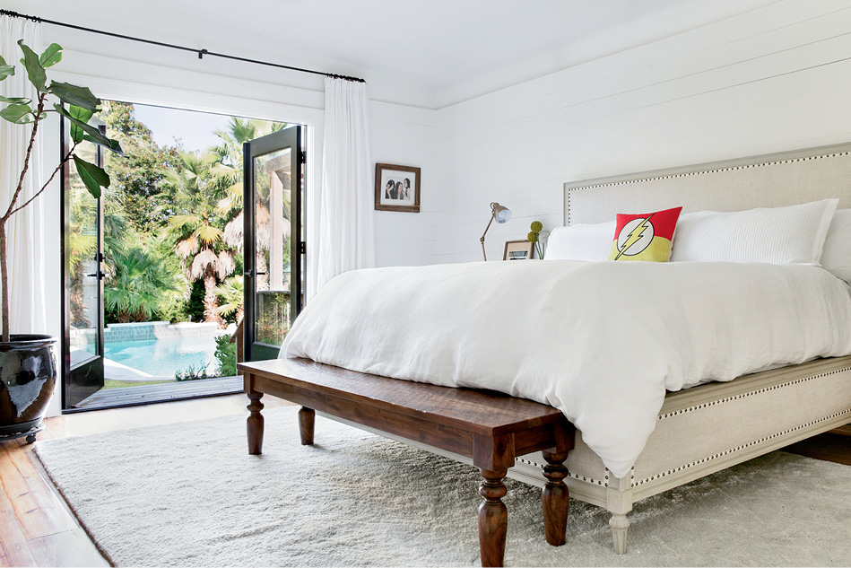 French doors lead to a pool and a striking cabana designed by David Thompson.