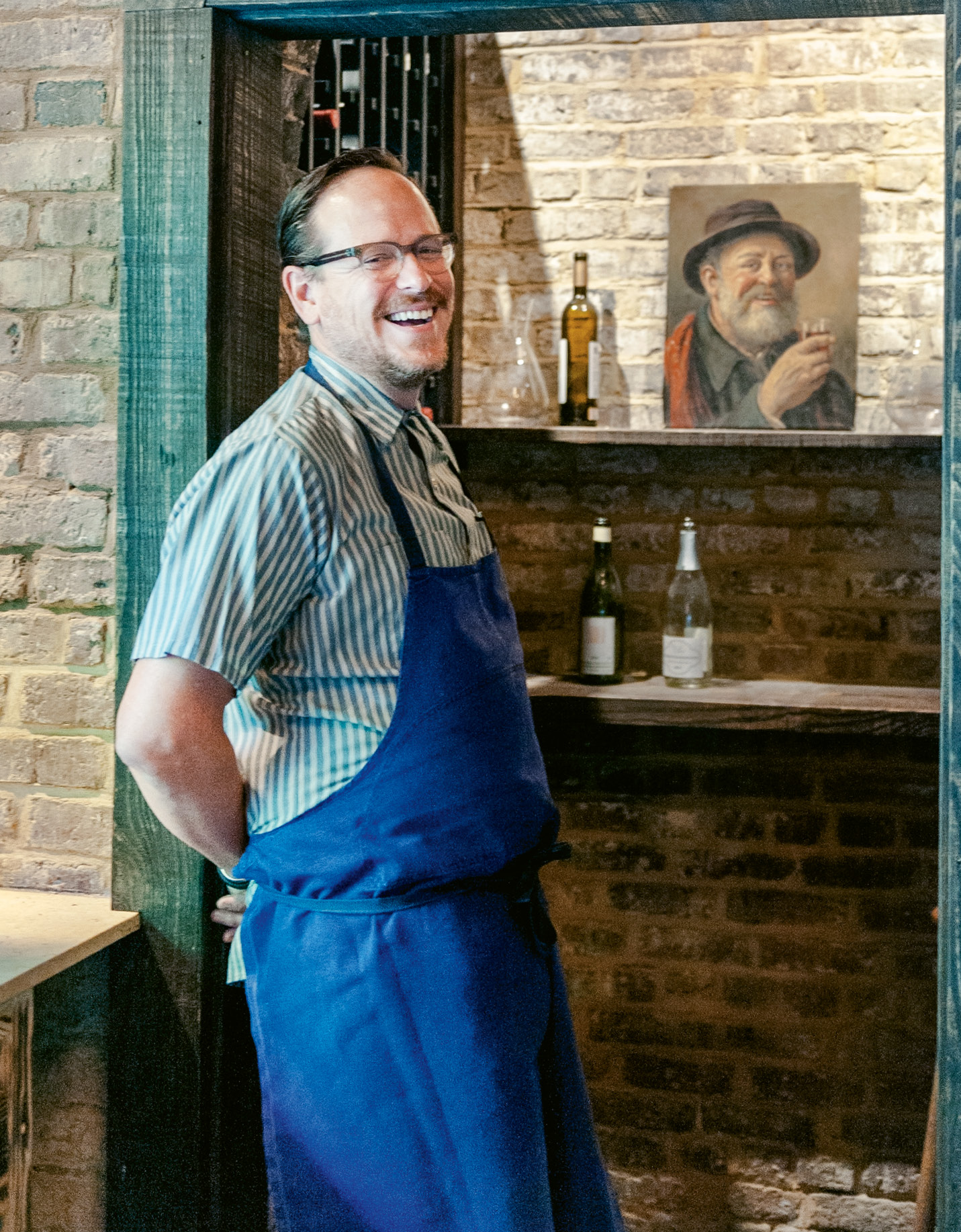 Damon Wise at the base of Scarecrow’s three-story wine cellar, renovated by local artisan Winston Wooten, who also built the restaurant’s central chandelier