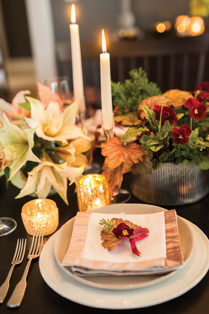 “You can make almost any palette work for the holidays with the addition of seasonal foliage,” she says. In this case, poinsettias in newer pink and white varietals add festive flair.