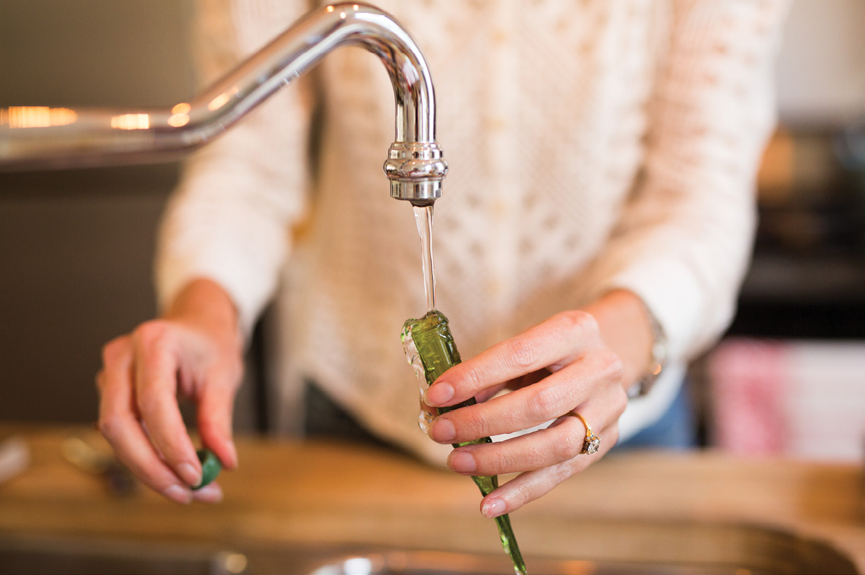 Cut poinsettia blooms and other white flowers, place them in water tubes, and tuck them into the arrangement.