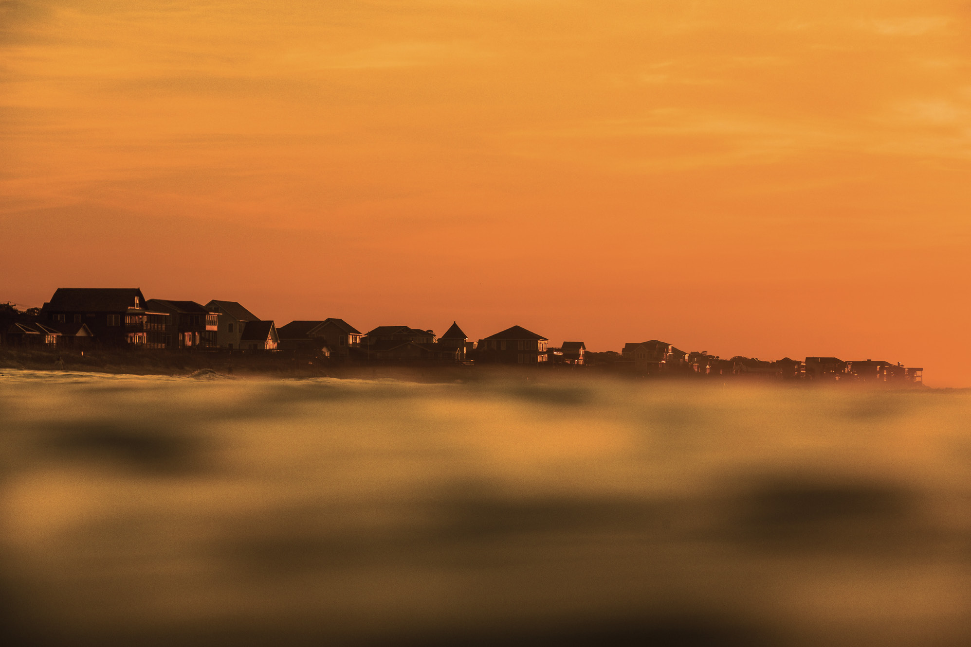The bright orange glow of a summer sunrise near East 4th Street