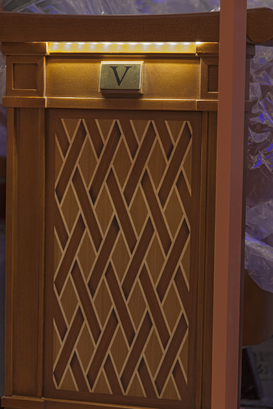 The artful weave of Charleston sweetgrass baskets inspired the inlaid wood pattern of aisle-facing seats...