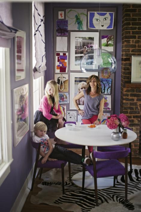 Angie, Loulou (11), and Sasha (seven) in the dining room, which is separated from the galley kitchen by a small partition. The white Tulip table is an eBay find, the chairs are 1960s Danish, and the clear globe pendant is by Kartell.