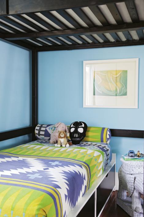 Sasha’s bed is outfitted with a graphic tapestry from Urban Outfitters; Angie had the bolster pillow made from the same fabric.