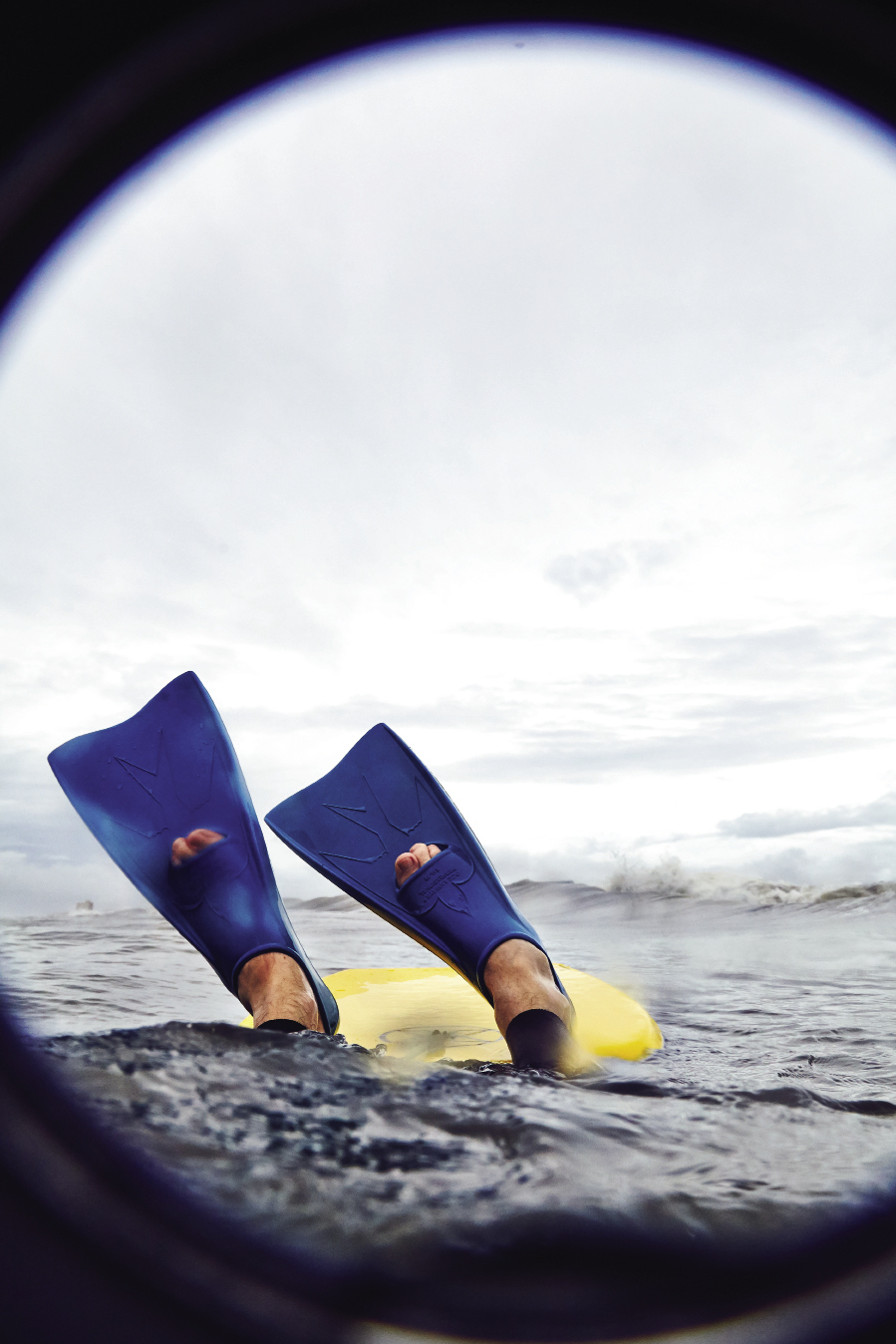 Photographer Peter Frank Edwards dives under a wave.