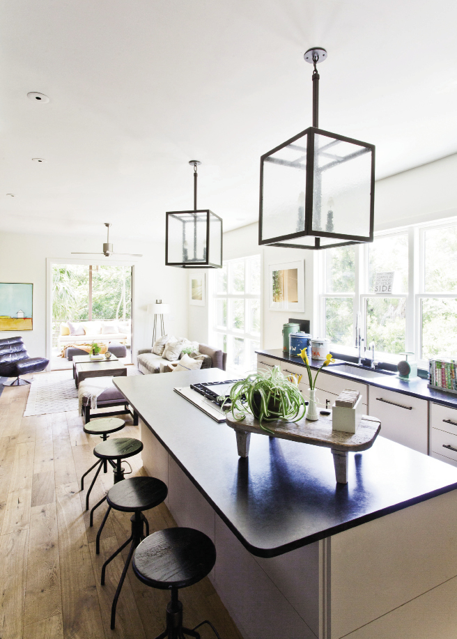 A bank of windows replace overhead  cabinetry in the kitchen.