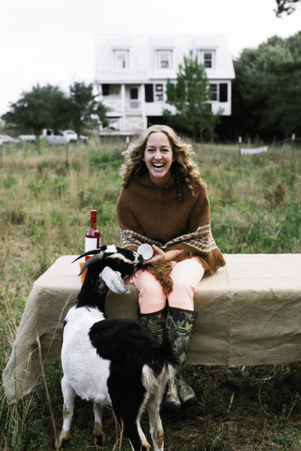 Getting Her Goat: Tara plays with Georgia behind their Awendaw home. The couple hopes to increase the herd by fall, which looks promising, as one of their four goats is pregnant with twins.