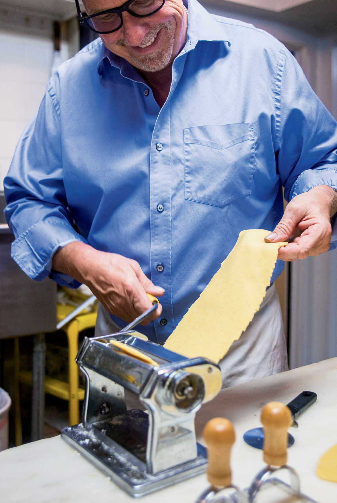 After kneading the pasta dough, Vagasky rolls it out with a hand crank, then stamps out individual raviolis and fills each with a shrimp and a dollop of ricotta.