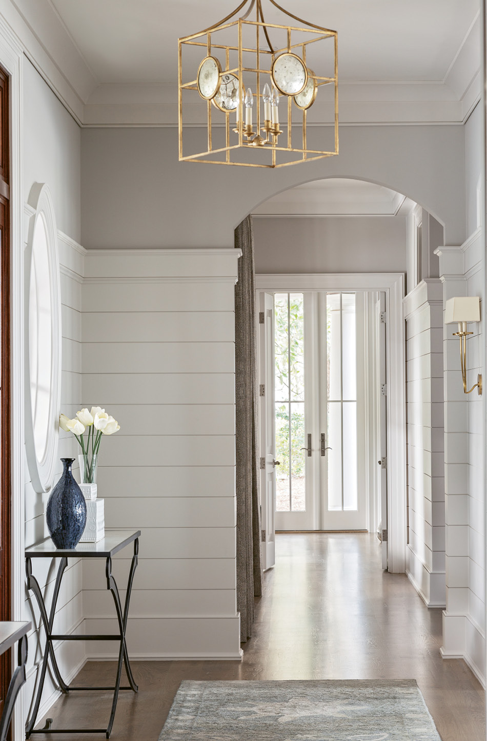 MUTED HUES: The Dajanis’ color palette is muted blues and greys, alongside yellows, creams, and bold browns, all of which stem from the front entry rug, designed at Fine Rugs of Charleston and made in Tibet.