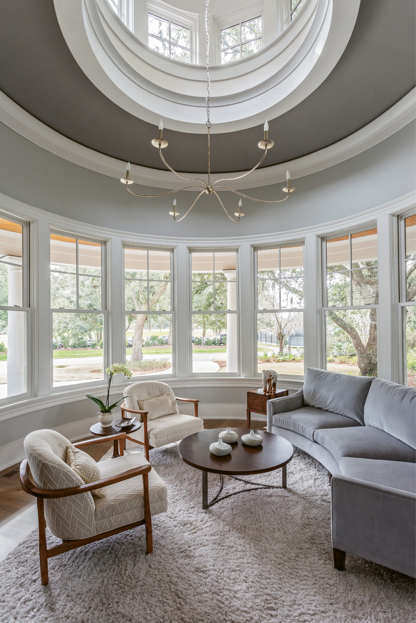 SIT BACK &amp; RELAX: “When we were furnishing the home, the focus was always on how the spaces would be used,” says Theresa T. Morton of Studio TTM, one of the project’s interior designers. Copious seating areas, such as the circular sitting room and upstairs den, boast a multitude of comfy chairs and oversized sofas from Precedent and Sherrill in a collection of subtle, patterned fabrics that complement the exterior views without detracting from their splendor.