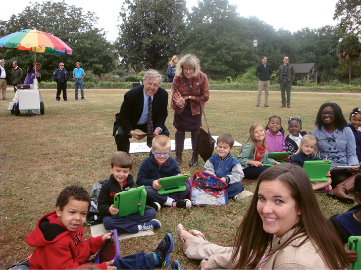 Fresh Connection: Adding free Wi-Fi to the city’s parks is one of many initiatives supported by the Messners’ Speedwell Foundation. The rollout began at parks closest to under-resourced neighborhoods, giving more families Internet access. Here, the couple visits with some students from Carolina Voyager Charter School at the Hampton Park wireless connection celebration.