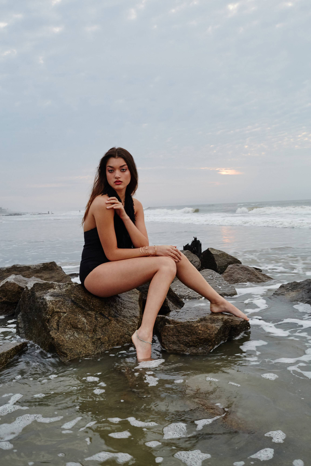 Nix + Row fringe one piece in black, $150 at nixandrow.com; Kate Davis “tropic” 14 K gold cuff, $28 (sold separately); “Barbed” 14 K gold-filled necklace, $128; “Islet” 24K gold anklet, $85; all at katedavisjewelry.com; “Miro” gold-plated cuff, $125, and  turquoise 22K gold-plated pendant necklace, $75; both at Croghan’s Jewel Box; Julie Vos “Belize Stud” earrings, $68 at Gwynn’s of Mount Pleasant; David Yurman “Venetian Quatrefoil” 18K yellow gold stacking rings, $875 at REEDS Jewelers; Gabriel &amp; Co. Bamboo 14 K yellow gold diamond ring, $1,900; and Twist 14 K yellow gold ring, $510, both at Polly’s Fine Jewelry; Currie Jewelry 14K gold wrap wring, $28, and 14K gold-filled stacking rings, $48, both at curriejewelry.com