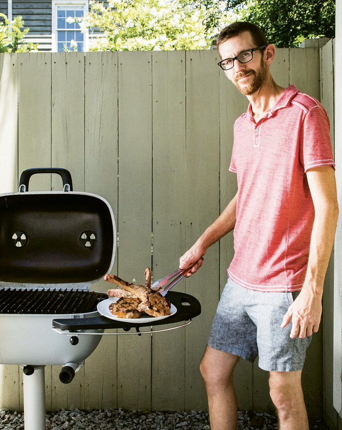 Lewis cooks seasoned pork chops on  a PK 360 Grill and Smoker. If the coals in your grill go out, the pitmaster offers this advice: “Stoke them up with a hair dryer. It works like magic.” (He keeps one in the back of his truck.)