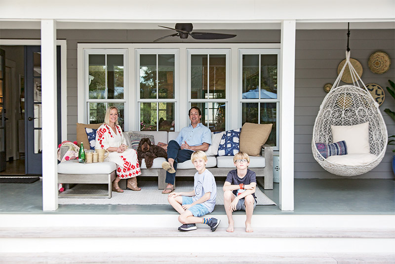 Allison and Bright Williamson; their 11-year-old twins, Ben and Henry; and Labradoodle Chief relax on the back porch.