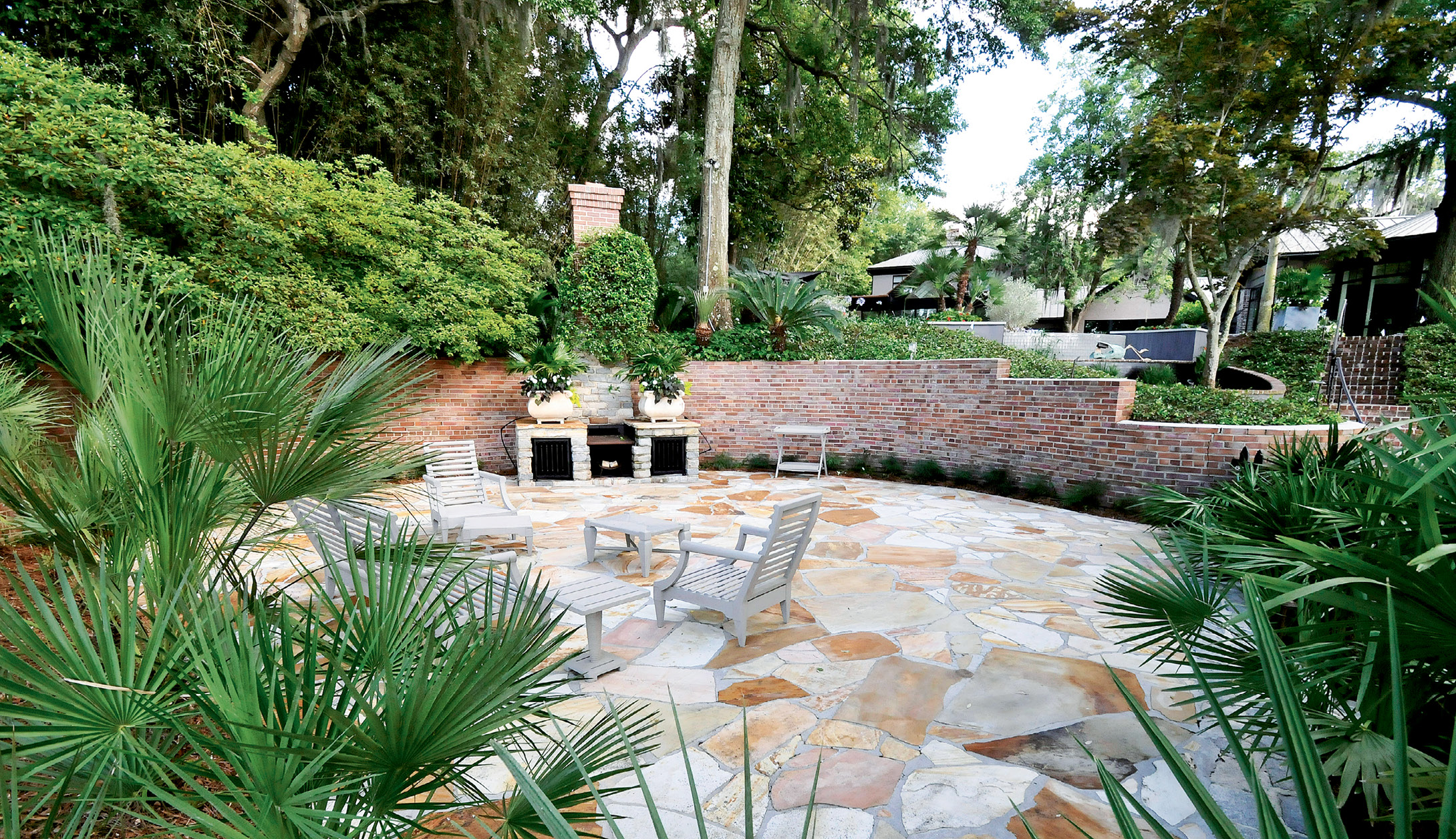 Iron grates were added to the existing brick fireplace to dress it up a bit. The outdoor room is a popular spot for oyster roasts and entertaining.