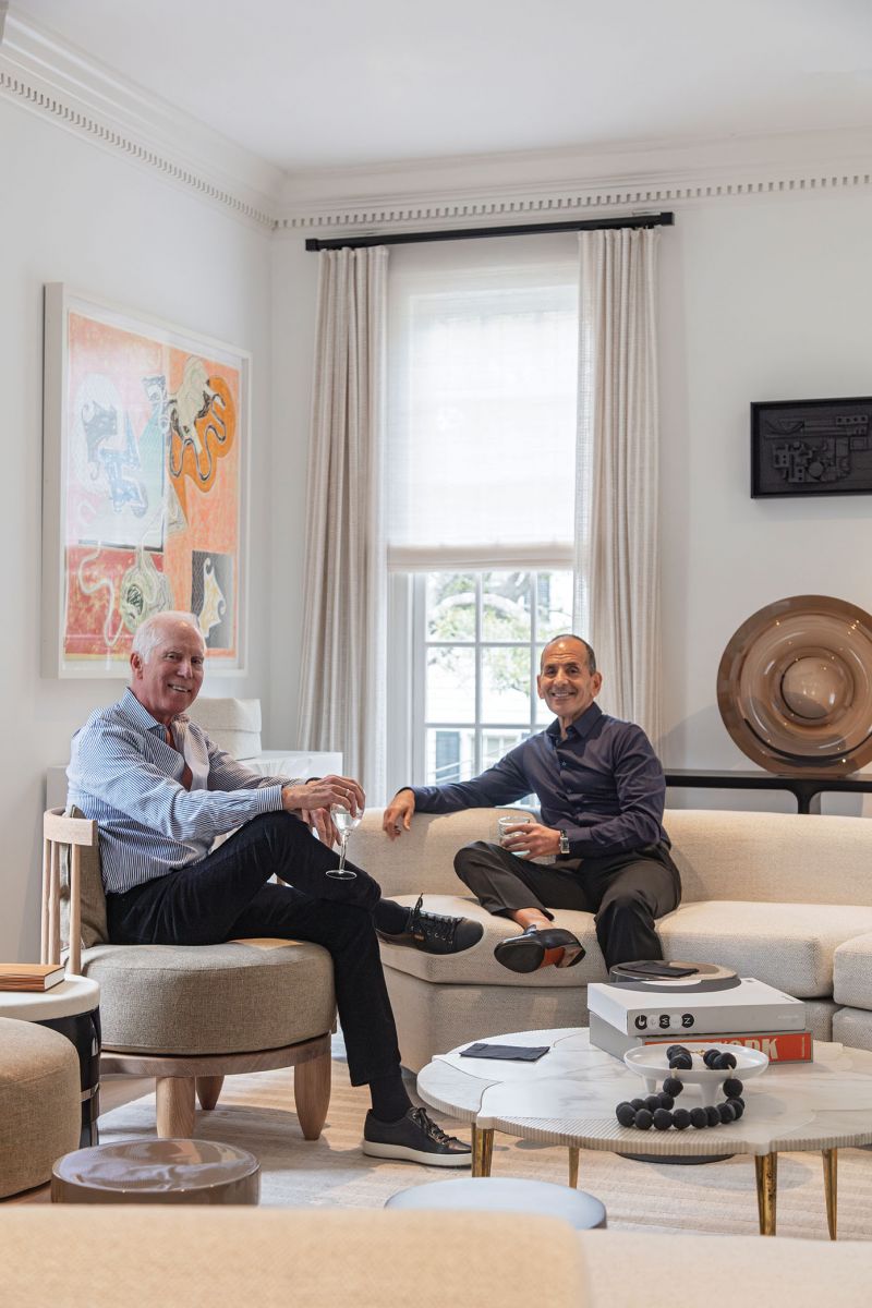 Two features enticed Lee Bell and Fotios Pantazis (left) to purchase this charming home for their retirement. First: behind its historic-seeming exterior lies a more modern construction—the house was built in 1990—with an open floor plan as an ideal canvas to showcase the couple’s stunning art collection. Second: windows galore allow natural light to flood the interior.