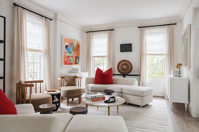 In turn, these bookend one of a pair of angled sofas designed by David Mitchell Brown and topped by Pierre Frey pillows. The sofas encircle a mid-century, marble and brass coffee table discovered at a New York antiques store. “This piece was the jumping-off point for the design of the house,” says Brown.