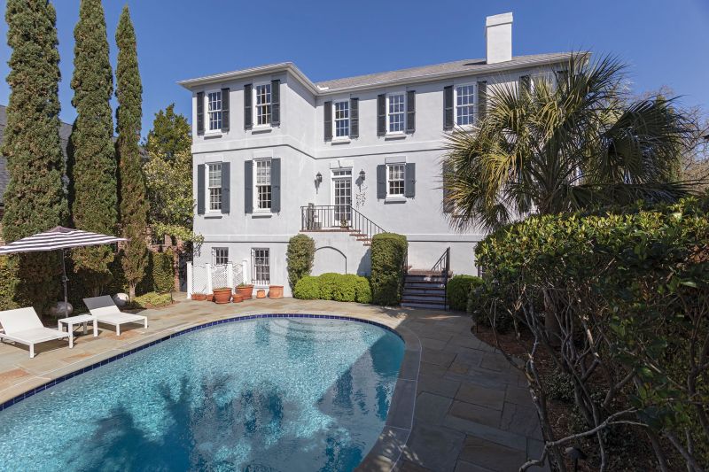 The sun-dappled backyard houses a pool and is also accessible from the ground-floor bedroom, which Foti uses as a gym for his work as a medical exercise specialist. The top of the stairs, just outside the back door, is his favorite spot. He loves to sit here, next to a water feature gifted by his niece, and soak up the sun.