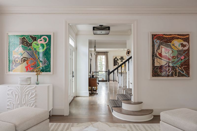 In the formal living room, two of three Frank Stella “Shards” lithographs sit atop two Dorothy Draper-inspired commodes from Baker Furniture.