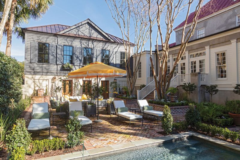 A rare double lot allowed the Hardees to build an addition for a primary bedroom suite and pool house. They also put in a pool and expanded the patio to maximize party space. The towering crepe myrtles and holly bushes are the only remnants of the previous owner’s yard.