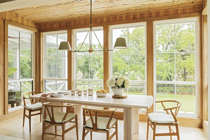 The design team and family went back and forth on whether to situate the dining space in what’s now the sitting area, but all are happy with where it landed. Pecky cypress makes the dining nook feel like an extension of the backyard, and the dining table and bench by Eric Brooks of Brooks Custom Woodworks and Hans Wegner-designed “Wishbone” chairs from Design Within Reach perfectly suit the narrow space.