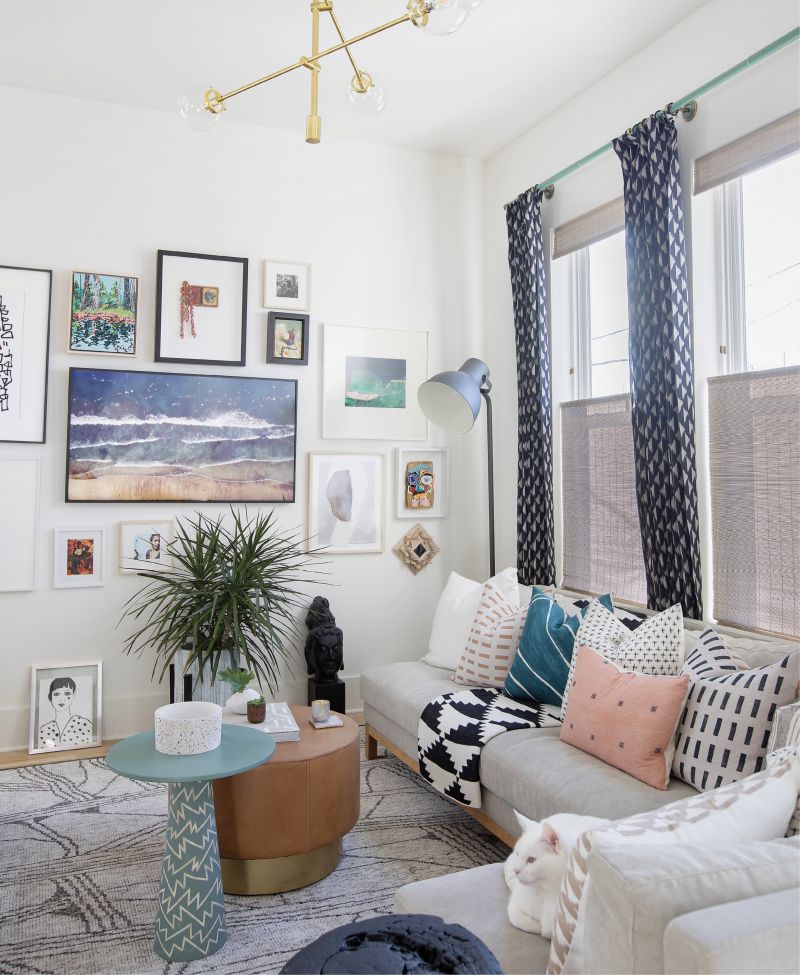 HIDING IN PLAIN SIGHT: An eye-catching art wall—replete with pieces from local artists Nathan Durfee, Katherine Dunlap, Miles Purvis, and Nina Garner—dominates Vickers’s living room. But where’s the television? Front and center. The Samsung Frame TV blends in as a piece of art when not in use.