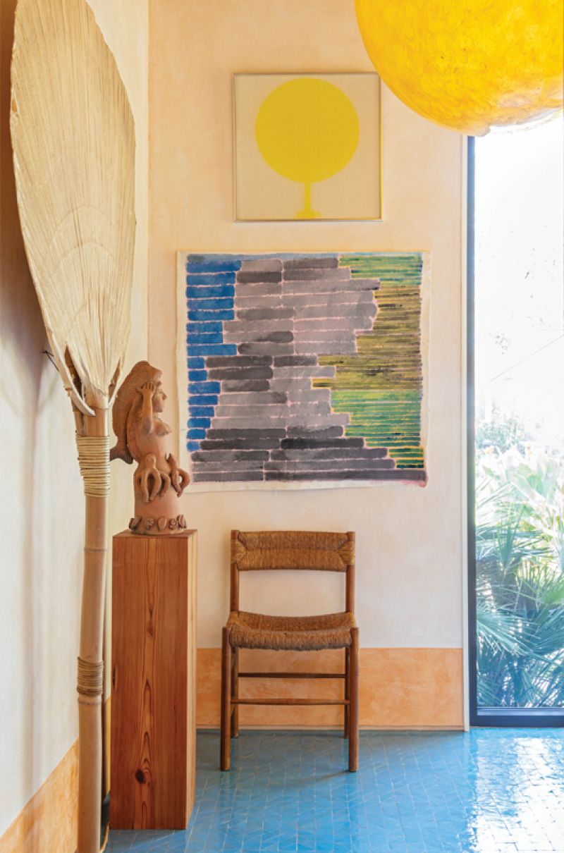 With blue zellige floor tile from Mosaic House and a vintage resin light fixture from Maisonjaune Studio in Paris, the entrance evokes the ocean and the sun. An original Uchiwa floor lamp by Ingo Maurer pairs with a painting by artist Gloria García Lorca and a “Sirena” sculpture by master potter José García Antonio from Ocotlán, Mexico.
