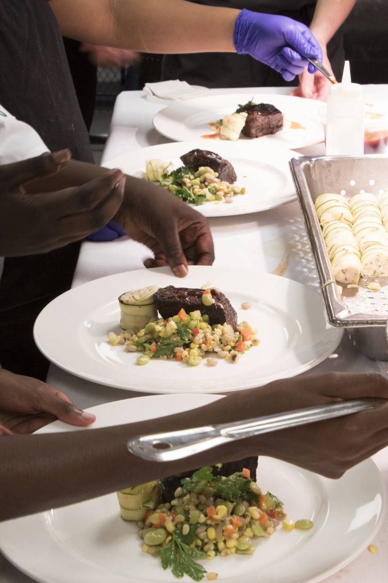 The “little chefs” add the finishing touches to a dish.