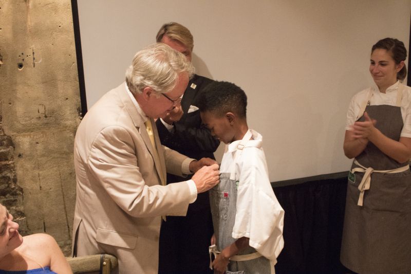 Louis Yuhasz and DaVee Harned watch as Mayor Tecklenburg awards Jaylen Jones for his hard work with Louie&#039;s Kids.