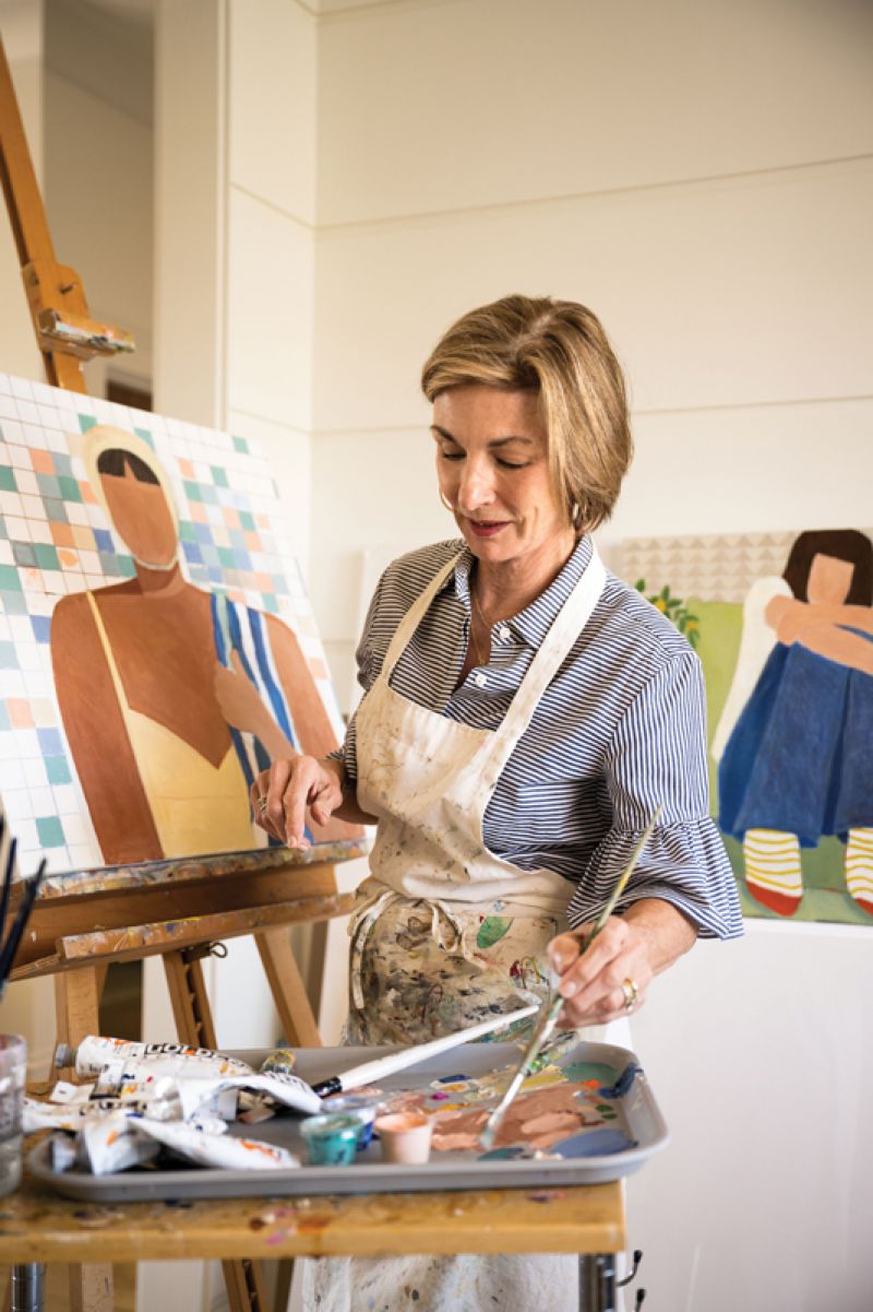 Creative Space: With no room in the floor plan for Debby’s studio, the architect cleverly transformed an open area at the top of the stairs, outfitting the window nook with cabinets and a sink. A large closet behind a jib door provides storage for canvases and a rolling cart with all her supplies.