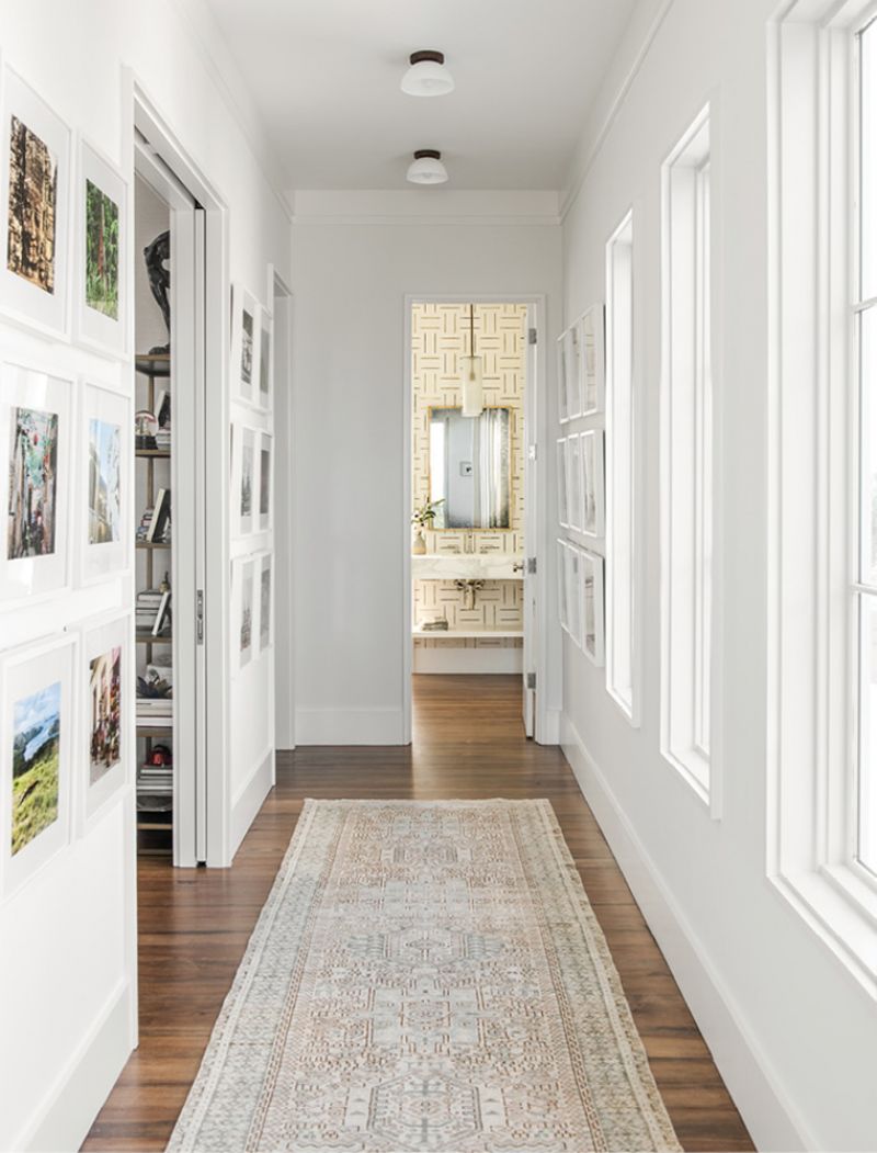 Downstairs, the corridor passes Melissa’s office as it leads to the guest bath and media room. The walls are full of photographs from the couple’s many travels.