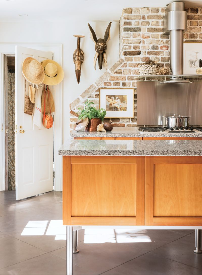 African masks and a watercolor painting by local artist Mary Whyte add warmth and personal meaning to the utilitarian, Bauhaus-style kitchen.