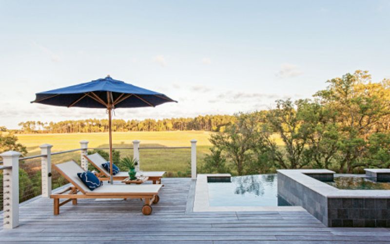 VIEWFINDER: Kingsley-Bate outdoor furnishings and a bluestone hot tub provide plenty of vantage points for taking in the backyard’s creek vistas.