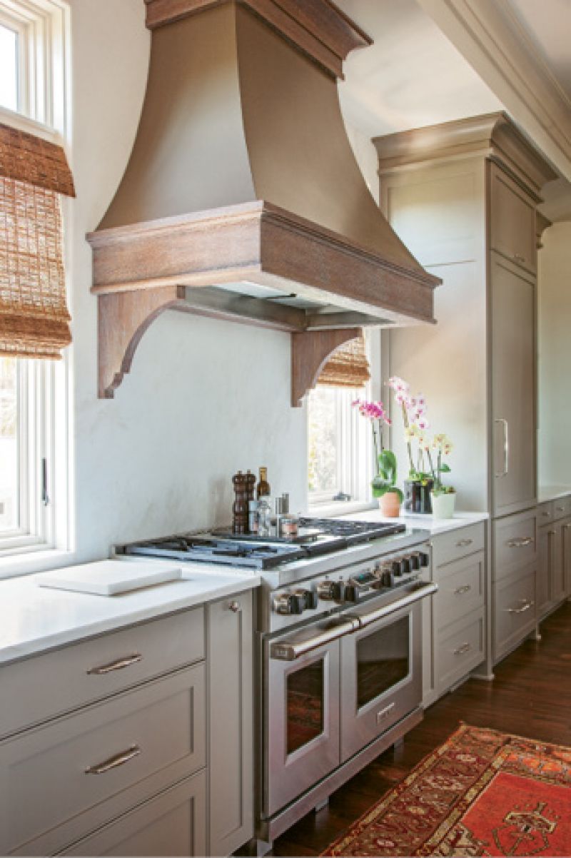 in the mix: Accent walls of brick and butted board help to set a welcoming, laid-back tone, while gilt-framed artwork and fixtures from Circa and Urban Electric add touches of elegance.