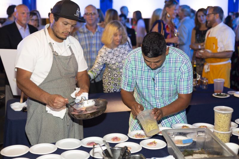 Chefs from The Obstinate Daughter and Wild Olive put the finishing touches on their beet ravioli with pistachio, sage, and dried orange.