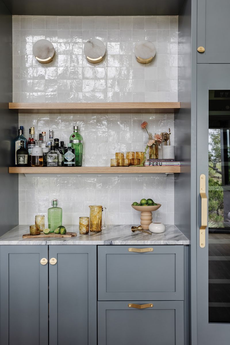 Calacatta Manhattan marble countertops complement the soft blues in the island and breakfast nook, and white oak kitchen cabinets continue the organic feel of the deco