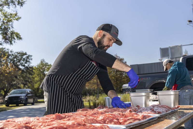 Meat gets seasoned by Leonard Botello from Truth BBQ in Houston, Texas.