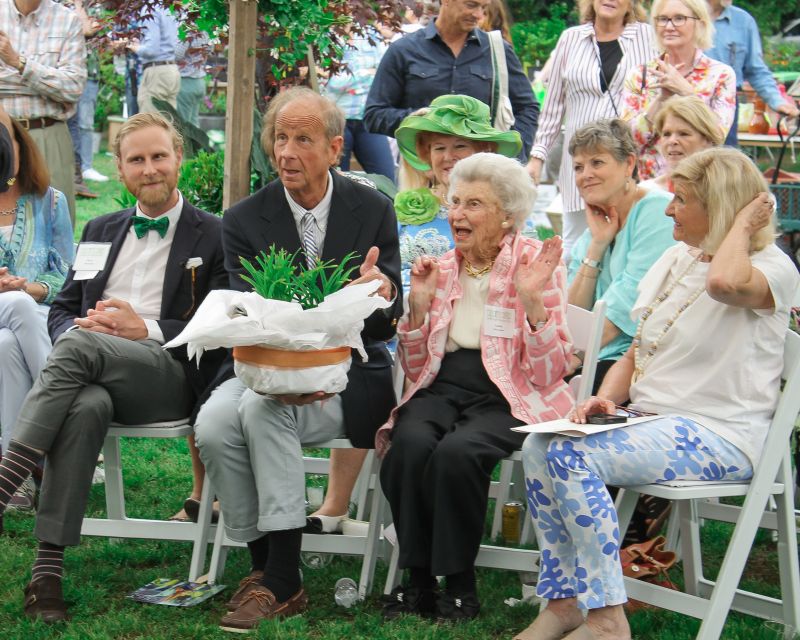 Kyle Barnette gives Lucile some Lady Lucille Lilies, which will eventually sprout orange blooms in her care.