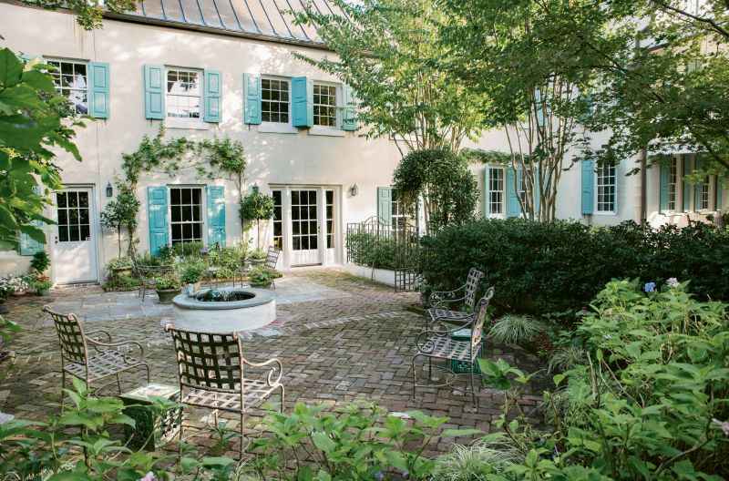 A climbing Sally Holmes rose frames a window into the family room.