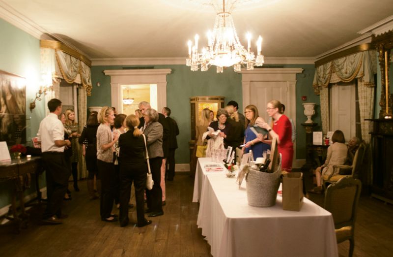 Attendees purchase copies in the parlor of the William Aiken House.